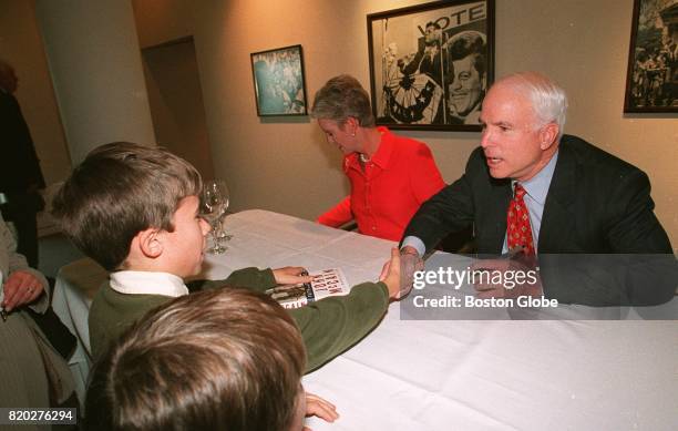 Presidential candidate Sen. John McCain greets some young admirers who want their copy of McCain's book "Faith of My Fathers" signed at the John F....