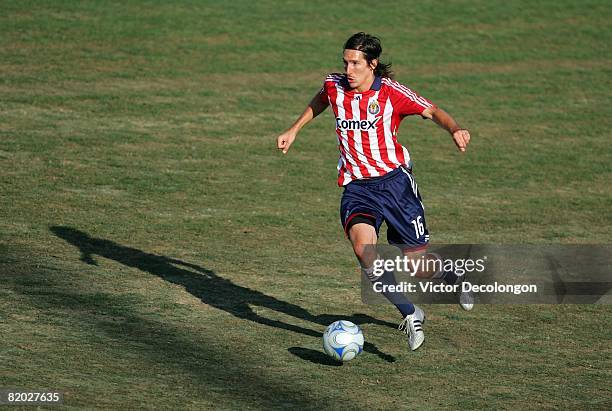 Sacha Kljestan of CD Chivas USA dribbles through midfield on the attack in the second half during their SuperLiga match against the New England...