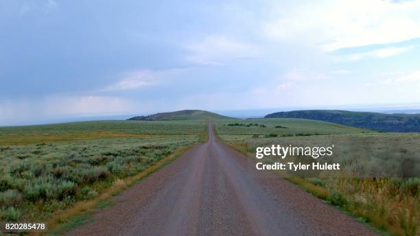 drive on gravel road in open plain summit steens mountain near malhuer wildlife refuge 20 - harney county stock pictures, royalty-free photos & images