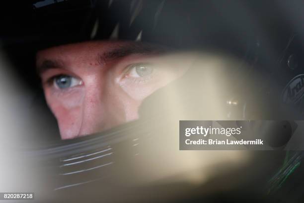 Dakoda Armstrong, driver of the WinField United Toyota, sits in his car during practice for the NASCAR XFINITY Series Lilly Diabetes 250 at...