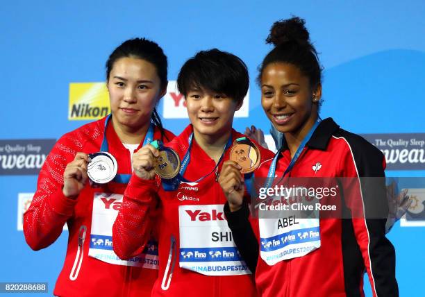 Silver medalist Han Wang of China, gold medalist Tingmao Shi of China and bronze medalist Jennifer Abel of Canada pose with the medals won during the...