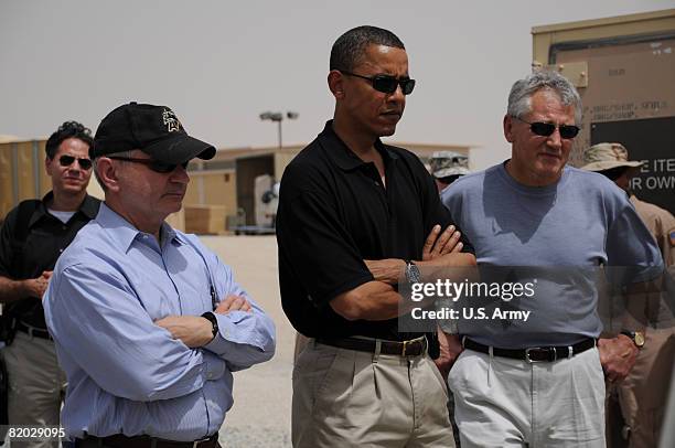 In this handout photo released by the U.S. Army, Presumptive Democratic presidential candidate Sen. Barack Obama studies boards displaying military...