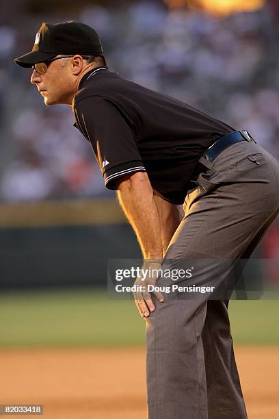 Umpire Dan Iassogna oversees the action at first base as the Pittsburgh Pirates face the Colorado Rockies at Coors Field on July 19, 2008 in Denver,...