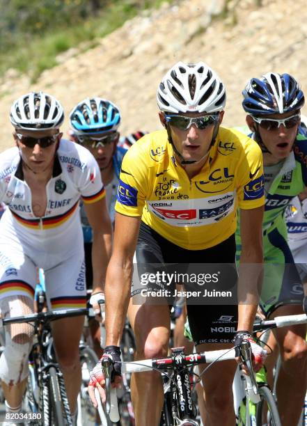 Race leader Frank Schleck of Luxembourg and team CSC Saxo Bank rides with the peloton in the yellow jersey up the Col de la Lombarde during stage...