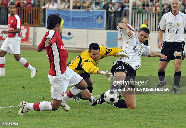 Arsenal's Mexican Carlos Vela vies with Szombathely's goalkeeper Daniel Rozsa and Richard Guzmics during a friendly football game in the local...