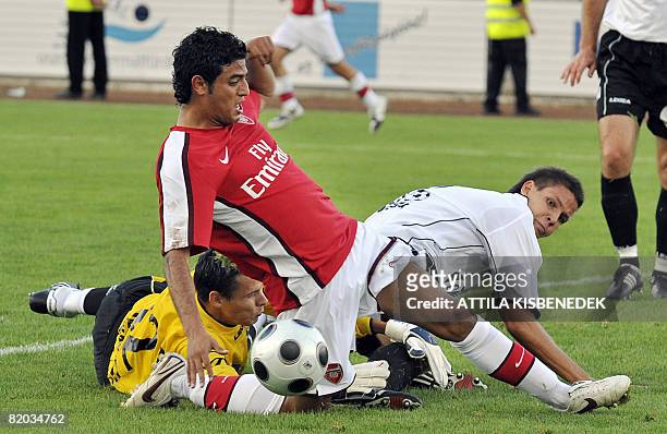 Arsenal's Mexican Carlos Vela vies with Szombathely's goalkeeper Daniel Rozsa and Richard Guzmics during a friendly football game in the local...