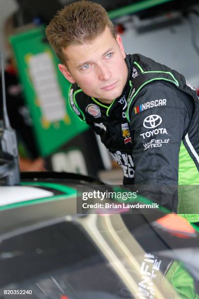 Dakoda Armstrong, driver of the WinField United Toyota, stands in the garage area during practice for the NASCAR XFINITY Series Lilly Diabetes 250 at...