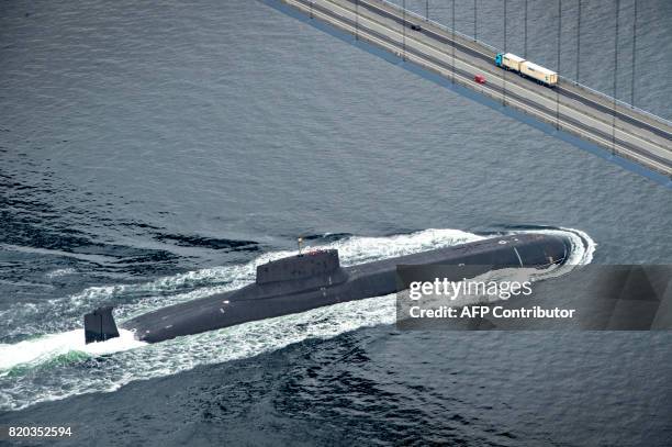 The Russian nuclear submarine Dmitrij Donskoj sails under the Great Belt Bridge between Jyutland and Fun through Danish waters, near Korsor, on July...