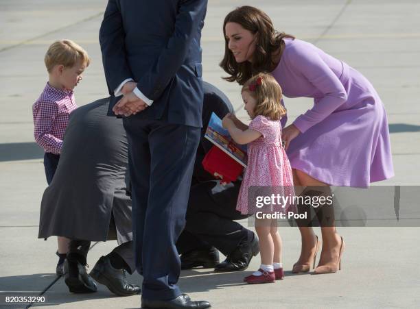 Prince William, Duke of Cambridge, Prince George of Cambridge, Princess Charlotte of Cambridge and Catherine, Duchess of Cambridge depart from...