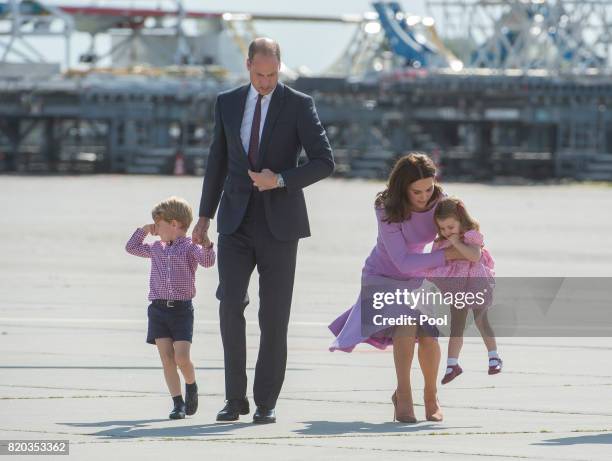 Prince William, Duke of Cambridge, Prince George of Cambridge, Princess Charlotte of Cambridge and Catherine, Duchess of Cambridge depart from...