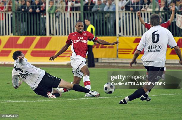 Arsenal's French Gael Clichy vies for the ball with Szombathely's Hungarian defenders Balazs Molnar and Richard Guzmics during a friendly football...