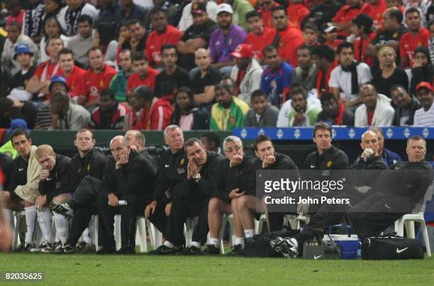 Sir Alex Ferguson of Manchester United watches from the bench with his coaching staff and substitutes during the Vodacom Challenge pre-season...