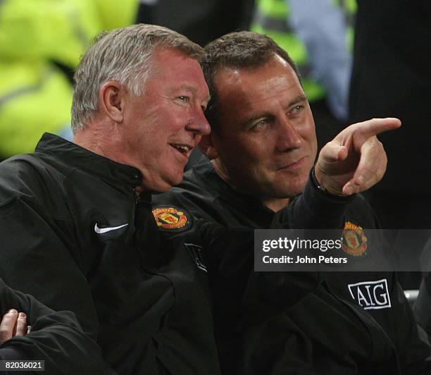 Sir Alex Ferguson and Rene Meulensteen of Manchester United watch from the bench during the Vodacom Challenge pre-season friendly match between...