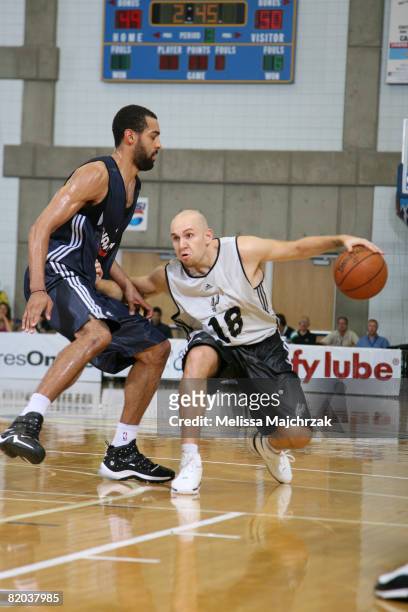 Brian Morrison of the San Antonio Spurs attempts to dribble around the defense of Brian Randle of the Atlanta Hawks at the Salt Lake Community...