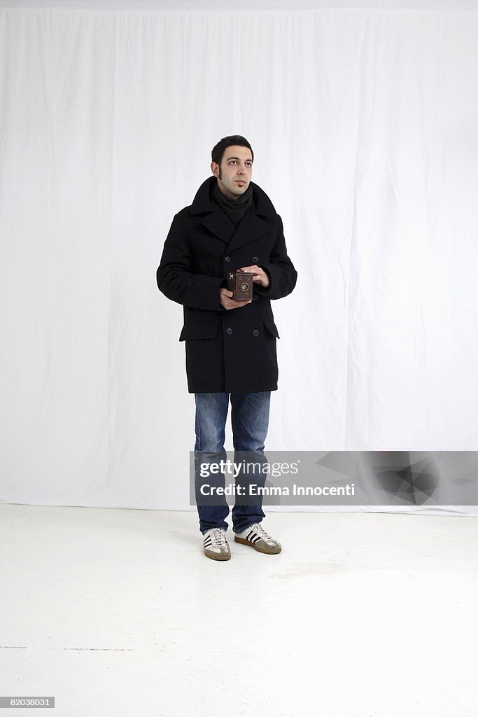 Young man with old camera