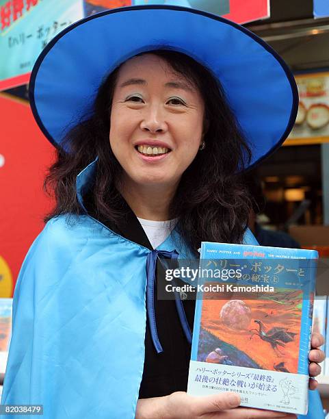 Say-zan-sha President Yuko Matsuoka, who translated the series, poses with newly published "Harry Potter and the Deathly Hallows" Japanese version at...