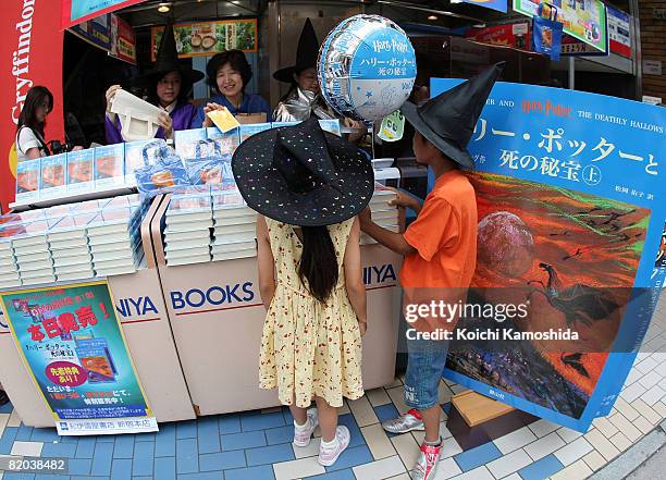 Japanese Harry Potter fans purchase their copies of the Japanese version of "Harry Potter and the Deathly Hallows" at Kinokuniya Bookstore on July...