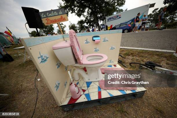 Cyclists pass a fake toilet with a sign that reads 'La Toilette du Dumoulin' during stage 19 of the 2017 Le Tour de France, a 222.5km stage from...