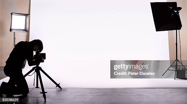 photographer shooting in studio. - photo shoot studio stock pictures, royalty-free photos & images