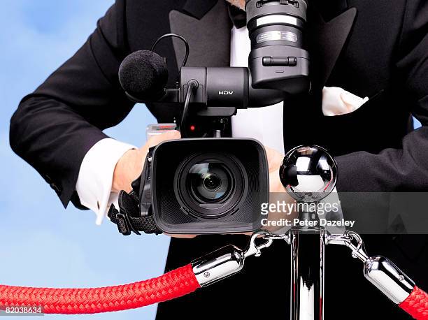 camera man in tuxedo with blue sky background. - one chance european premiere red carpet arrivals stock pictures, royalty-free photos & images