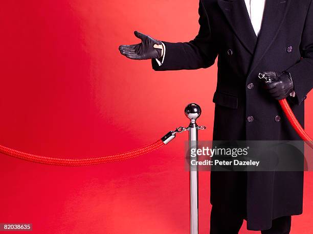 doorman at red carpet event allowing entry. - celebrities fotografías e imágenes de stock