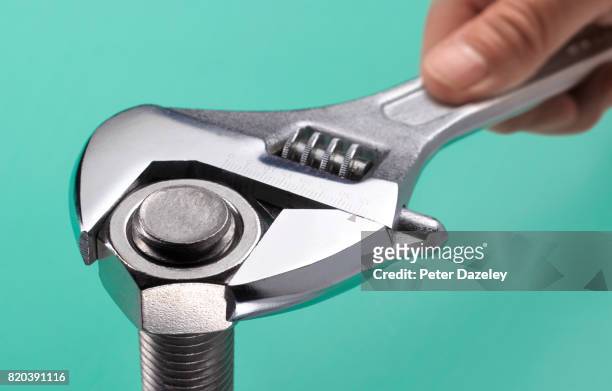 adjustable spanner and bolt close up - nut fastener stock pictures, royalty-free photos & images