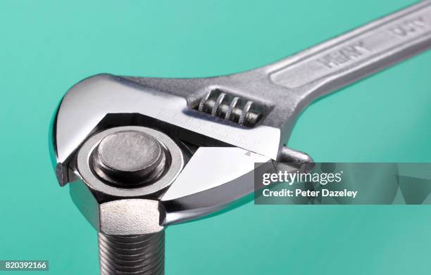 wrench and nut - adjustable wrench stock pictures, royalty-free photos & images