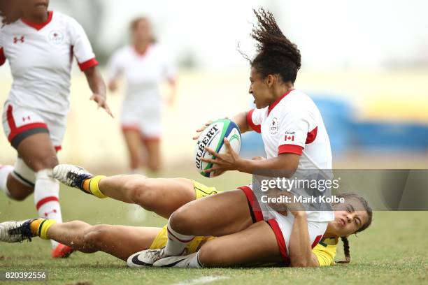 Olivia De Couvreur of Canada is tackled by by Lily Dick of Australia during the girl's rugby 7's gold medal final match between Austra and Canada on...