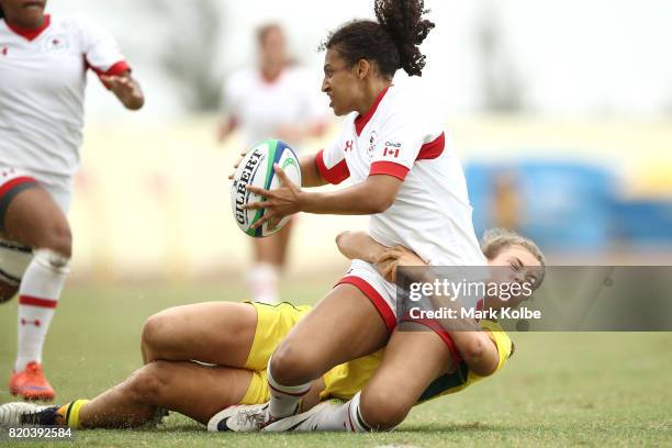 Olivia De Couvreur of Canada is tackled by by Lily Dick of Australia during the girl's rugby 7's gold medal final match between Austra and Canada on...