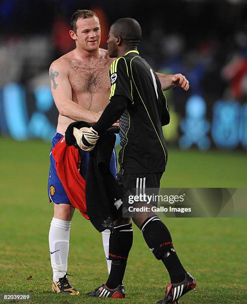 Wayne Rooney of Manchester United and Senzo Meyiwa of the Orlando Pirates in action on during the Vodacom Challenge match between Orlando Pirates and...