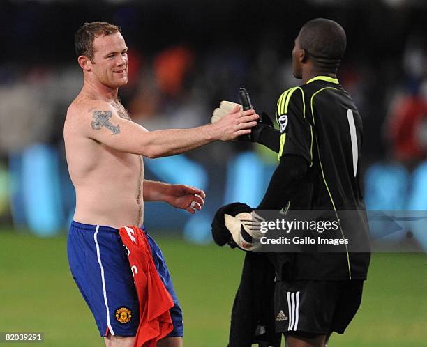 Wayne Rooney of Manchester United and Senzo Meyiwa of the Orlando Pirates in action on during the Vodacom Challenge match between Orlando Pirates and...