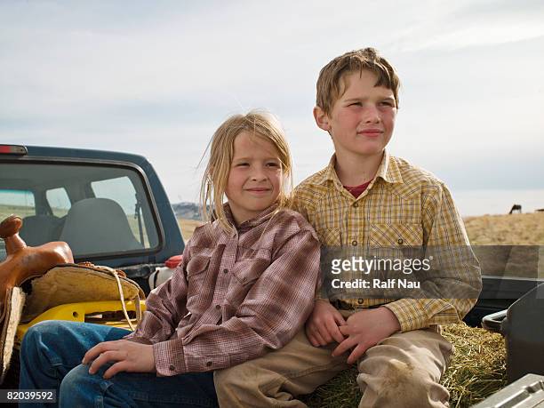 siblings in back of truck - young sister stock pictures, royalty-free photos & images