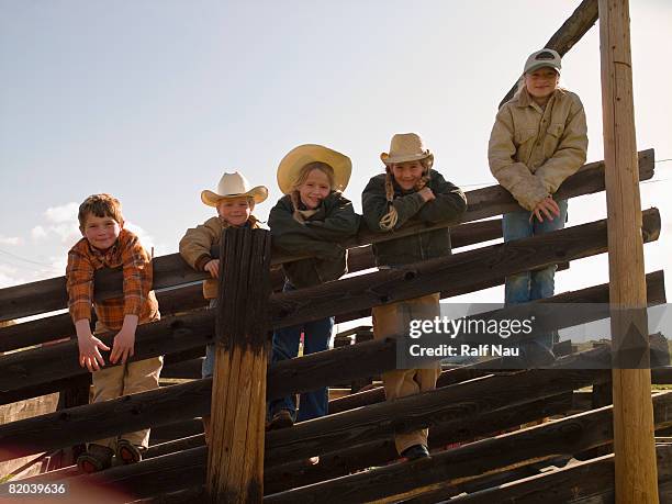 portrait of brothers and sisters on family ranch - ranch fence stock pictures, royalty-free photos & images