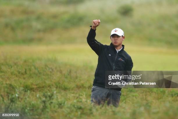 Si Woo Kim of Korea checks his yardage book on the 16th hole during the second round of the 146th Open Championship at Royal Birkdale on July 21,...