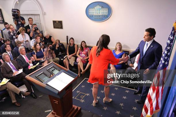 White House Principal Deputy Press Secretary Sarah Huckabee Sanders shakes hands with Anthony Scaramucci embrace during the daily press briefing in...