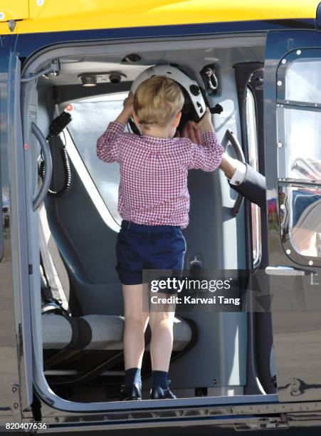 Prince George of Cambridge views helicopter models H145 and H135 before departing from Hamburg airport on the last day of their official visit to...