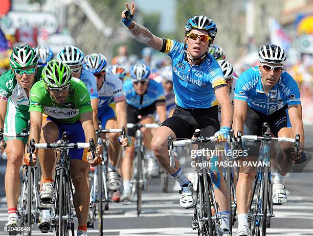 Britain's Mark Cavendish jubilates on the finish line, on July 17 2008, next to Spanish Oscar Freire , triple world road race champion and German...