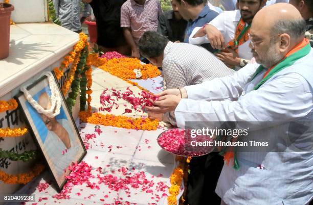 National President Amit Shah pays tribute to Father of the Nation Mahatma Gandhi as CM Vasundhara Raje and State BJP President Ashok Parnami look on,...