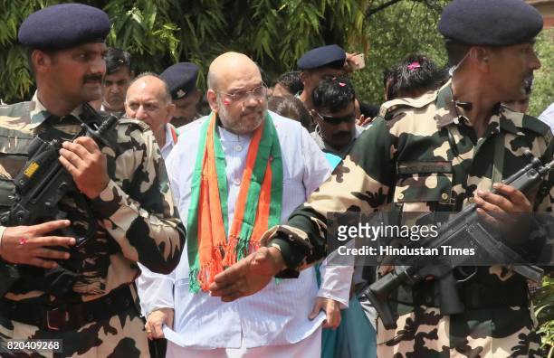 National President Amit Shah stops to pay tribute to Mahatma Gandhi, while on his way in a procession from Sanganer Airport to party office on the...