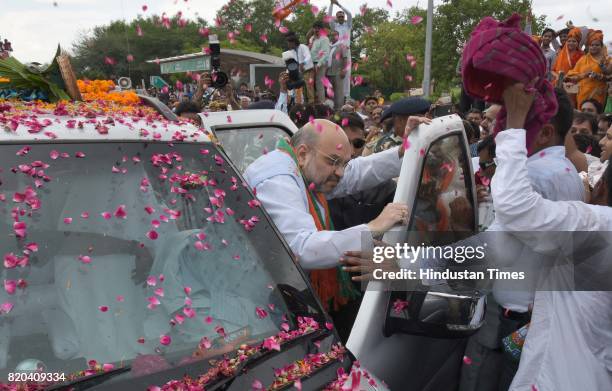 National President Amit Shah being welcomed by party men on his way in a procession from Sanganer Airport to party office on the first day of his...