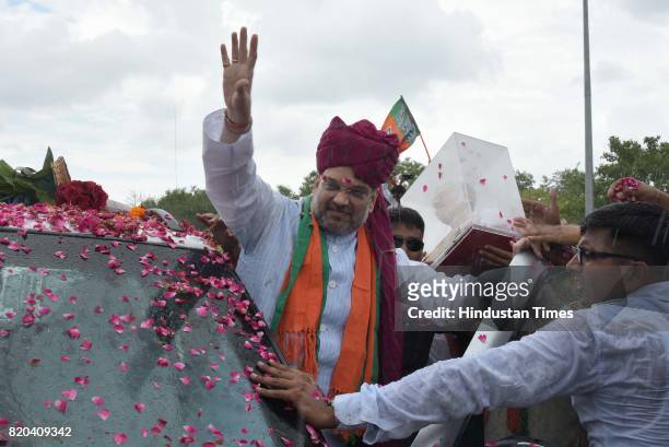 National President Amit Shah being welcomed by party men on his way in a procession from Sanganer Airport to party office on the first day of his...
