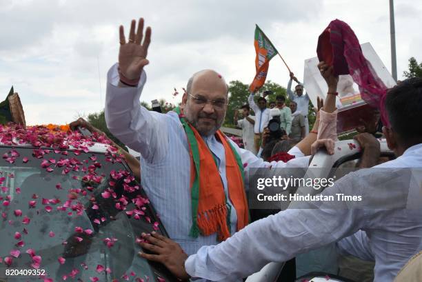 National President Amit Shah being welcomed by party men on his way in a procession from Sanganer Airport to party office on the first day of his...