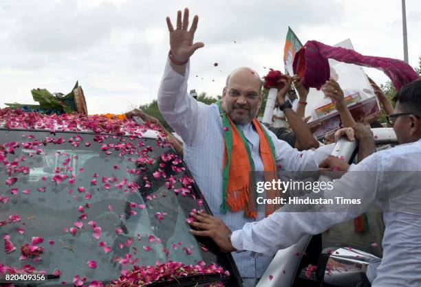 National President Amit Shah being welcomed by party men on his way in a procession from Sanganer Airport to party office on the first day of his...