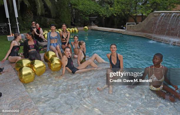 Models pose in the pool at the Lelloue launch party at Villa St. George on July 21, 2017 in Cannes, France.