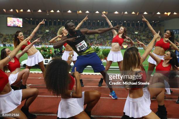 Usain Bolt of Jamaica struts his stuff alongside cheerleaders after victory in the men's 100m during the IAAF Diamond League Meeting Herculis on July...