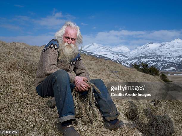 senior farmer in hornafjordur fjord, eastern iceland - iceland mountains stock pictures, royalty-free photos & images