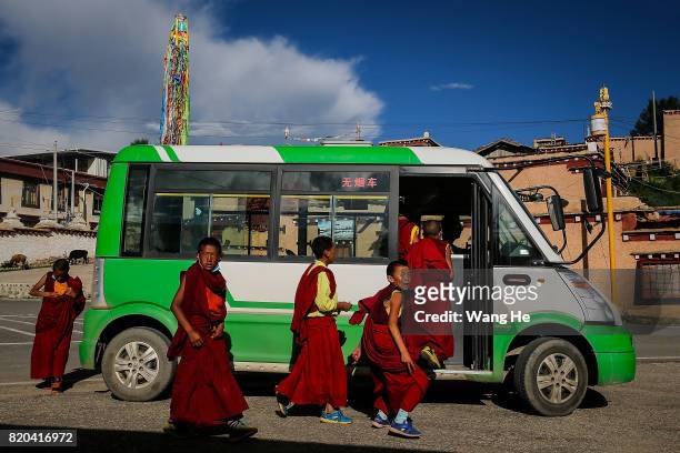 Tibetan Buddhist monks board a bus to leave the Long youth Cole Temple on July 21 ,2017 in Litang County, Ganzi Tibetan Autonomous Prefecture,...