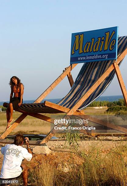 Girl poses for a photo at the beach of Marina di Pescoluse on August 11 in Salento, Italy. Salento is that strip of land that forms the heel of the...