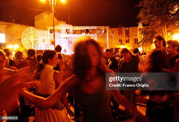 People dance the Pizzica, Local dance in the central square of Cutrufiano during 'La Notte della Taranta' festival on August 14 in Salento, Italy....