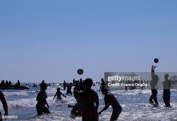 People play along Marina di Pescoluse beach on August 11 in Salento, Italy. Salento is that strip of land that forms the heel of the boot . It is...